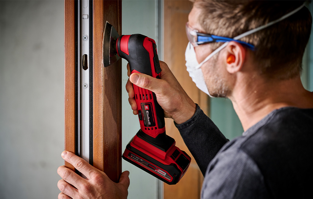 Muškarac brusi zid brusilicom za zidove i stropove, s tekstom „Na blog-članak“.