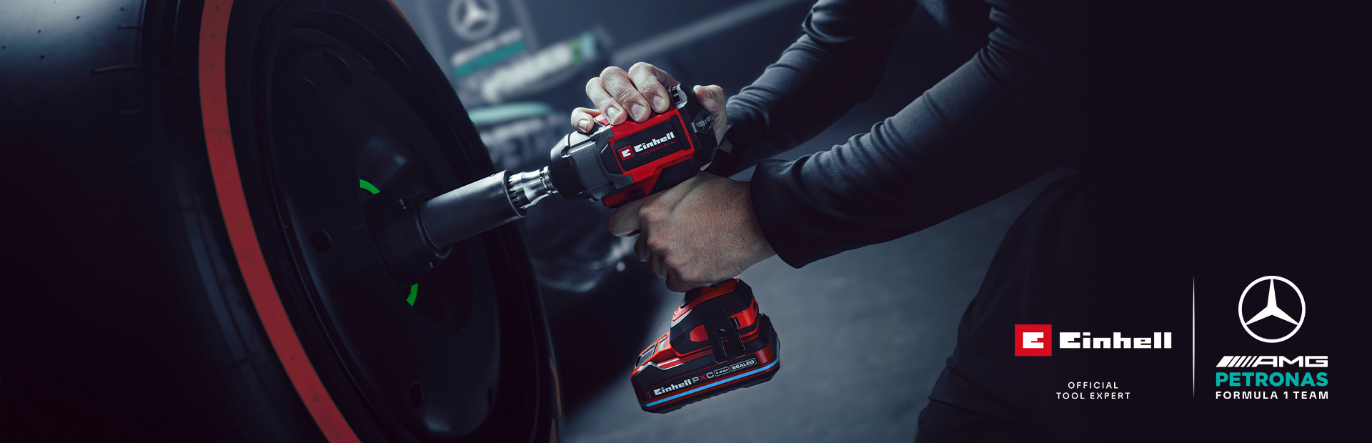 Einhell akumulatorski udarni odvijač u upotrebi na kotaču automobila, s oznakama i logotipom partnerstva Mercedes-AMG Petronas Formula One tima