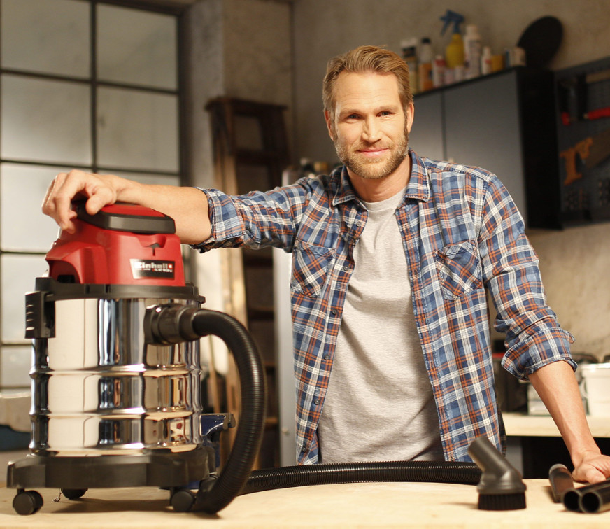 man with a wet / dry vacuum cleaner