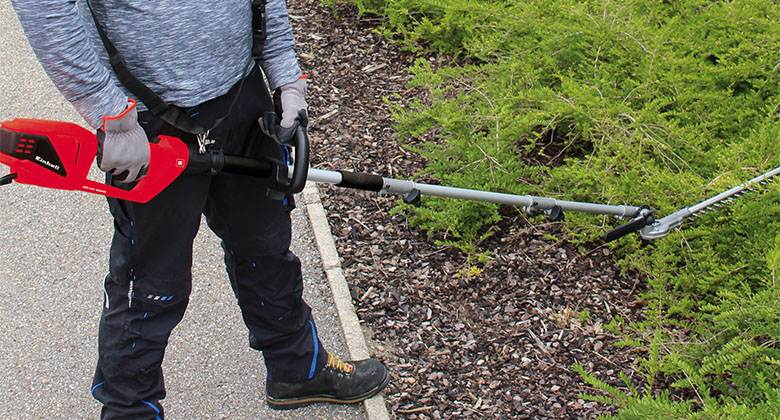 working with electric pole hedge trimmer