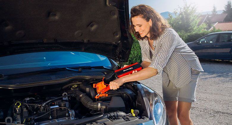 woman using a jump starter
