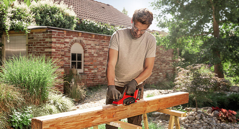 man working with an electric planer